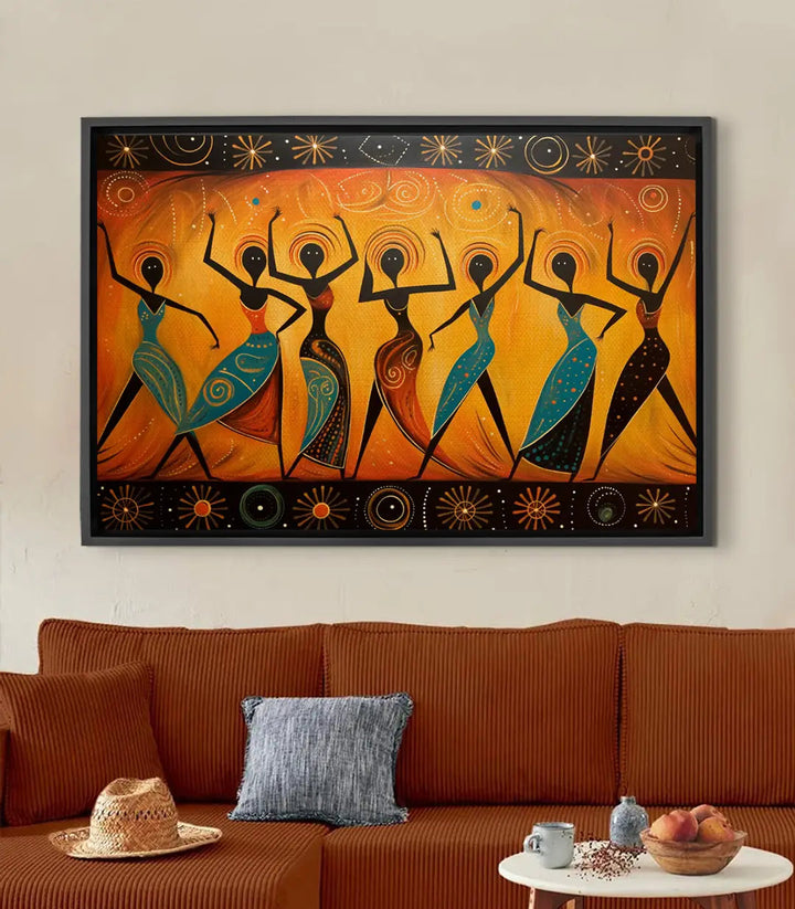 Tableau Tribal Dance — sept femmes dansantes silhouettes noires sur fond orange doré, motifs géométriques bleus rouges Massinart